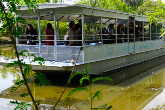 a boat sitting on the side of a river