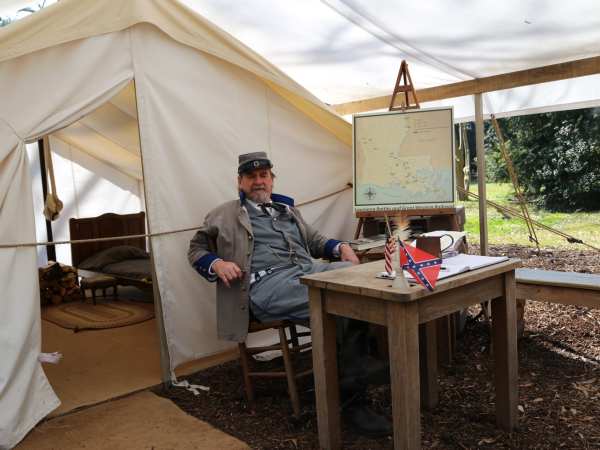 a man sitting in a tent