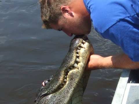 a man holding a fish in the water