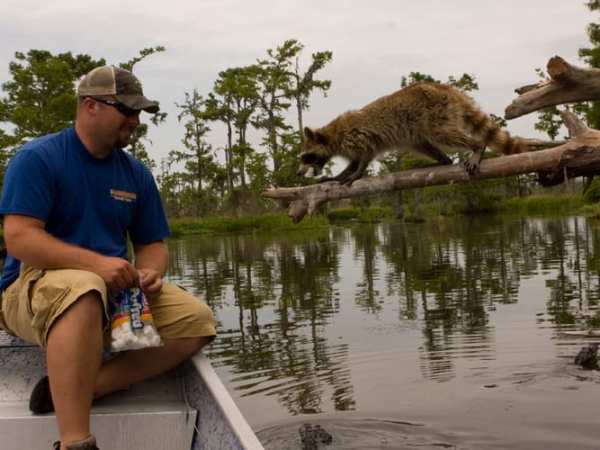 a man standing next to a body of water