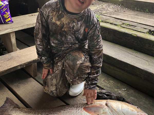 a person holding a fish