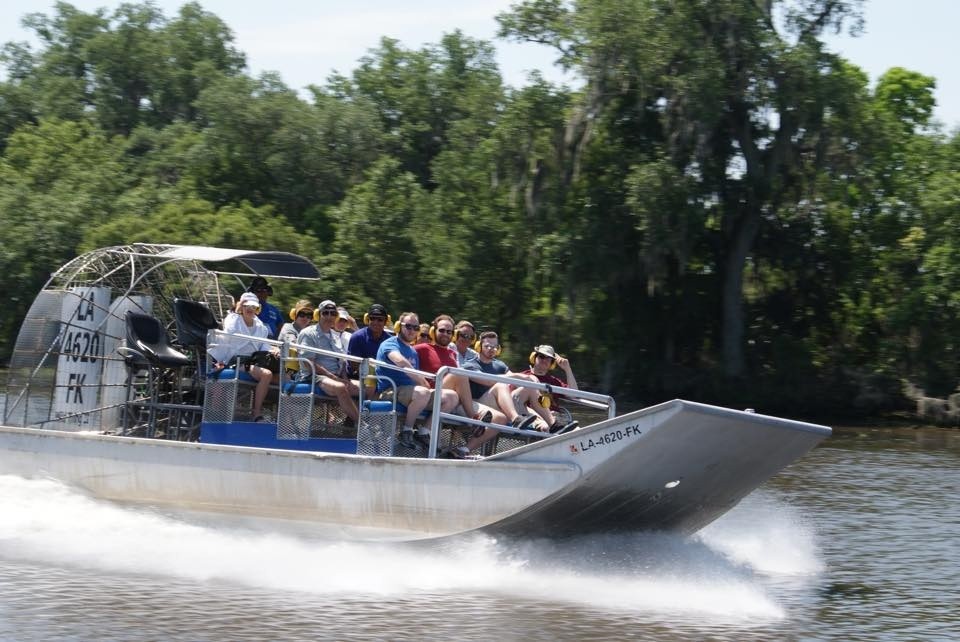 a group of people riding on an airboat